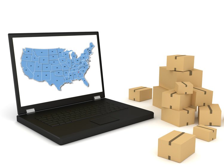 Laptop with the U.S.A. map showing national network of CRD Logistics Company New York and parcel packages beside it